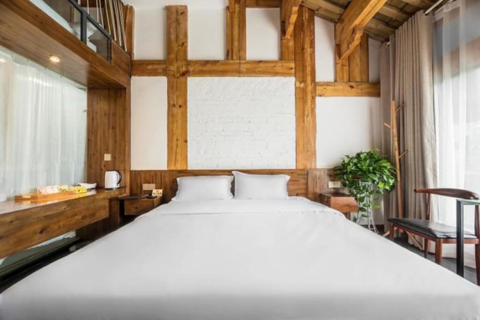 Imagen de la habitación del Hotel Floral Hotel Langzhong Pangmen College. Foto 9