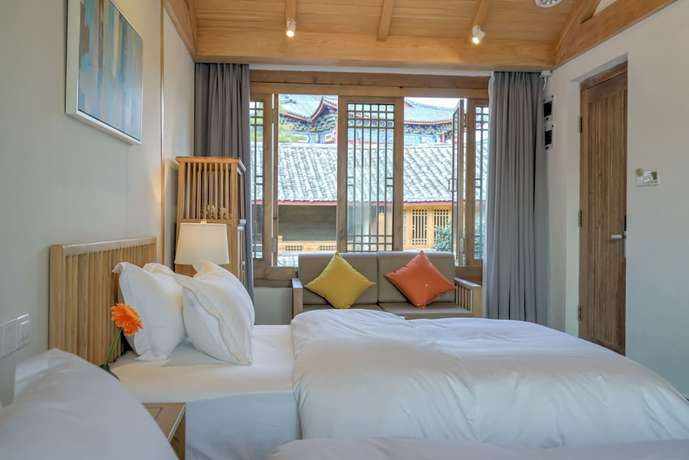 Imagen de la habitación del Hotel Floral Hotel Lijiang Huazizai. Foto 18
