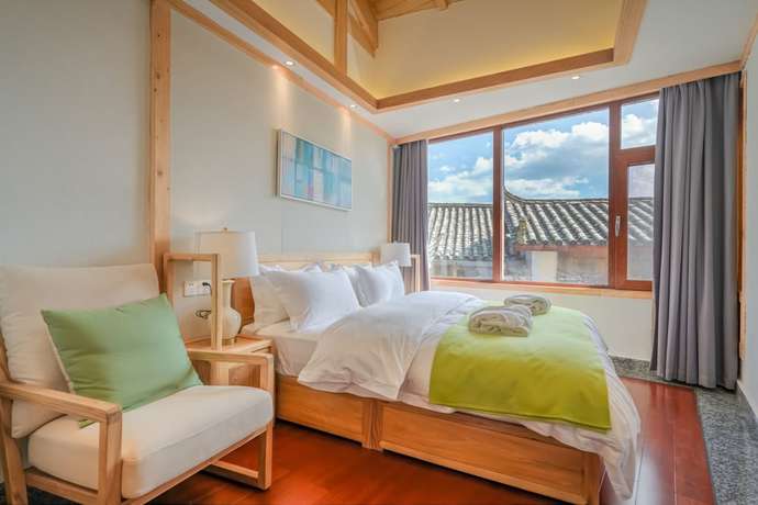 Imagen de la habitación del Hotel Floral Hotel Lijiang Huazizai. Foto 19
