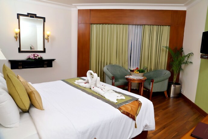 Imagen de la habitación del Hotel Gokulam Park. Foto 23