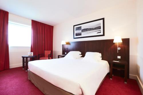 Imagen de la habitación del Hotel Golden Tulip CDG Airport Roissy. Foto 12