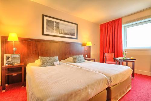 Imagen de la habitación del Hotel Golden Tulip CDG Airport Roissy. Foto 19