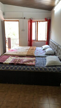 Imagen de la habitación del Hotel Goroomgo Colonel Cottage Lake View. Foto 15