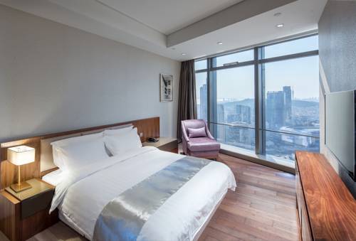 Imagen de la habitación del Hotel Grand Madison Qingdao Harbour View Central. Foto 2
