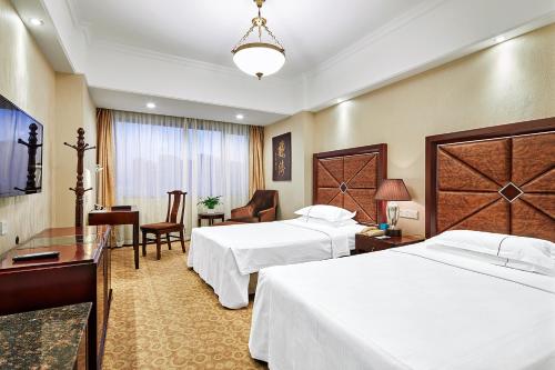 Imagen de la habitación del Hotel Grand Regency, Qingdao. Foto 11
