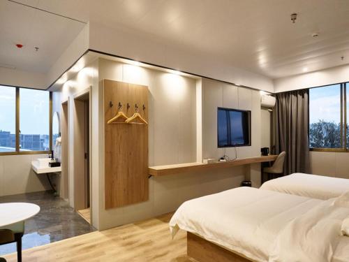 Imagen de la habitación del Hotel GreenTree Inn Express Suzhou Taicang West Nanjing Road. Foto 14