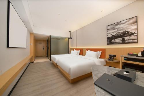 Imagen de la habitación del Hotel Guangzhou Baiyun Airport COCO. Foto 20