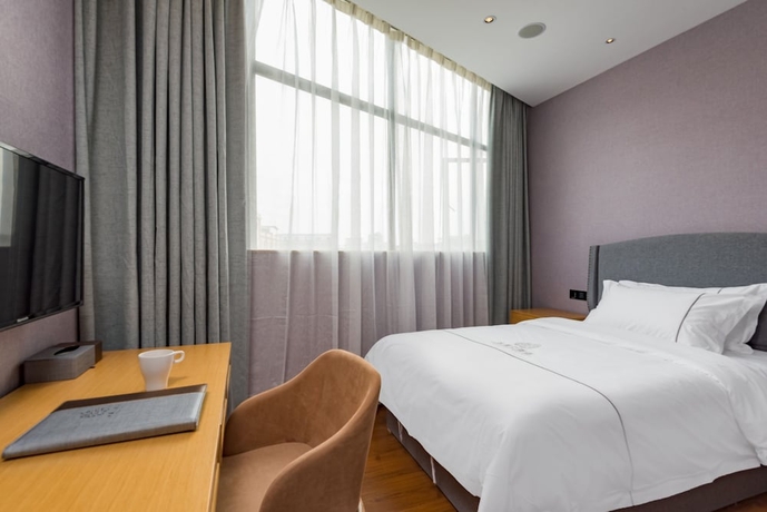 Imagen de la habitación del Hotel Guangzhou Mustin. Foto 6