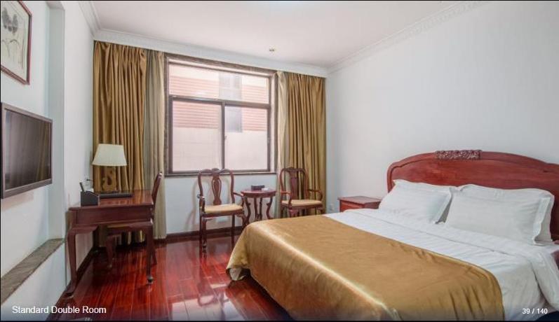 Imagen de la habitación del Hotel HUAJIANG HOTEL. Foto 2