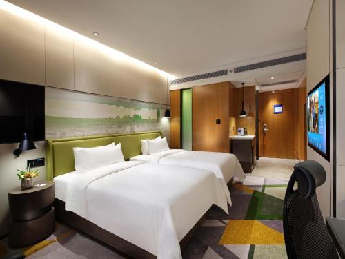 Imagen de la habitación del Hotel Hampton by Hilton Guangzhou Tianhe Sports Center. Foto 11
