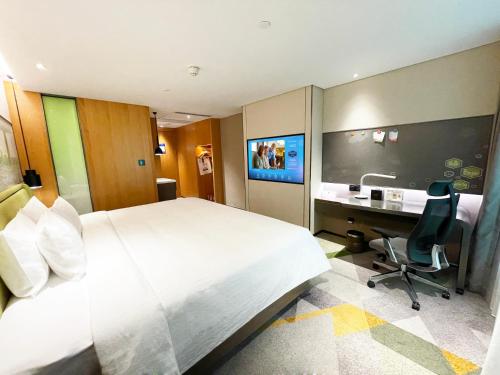 Imagen de la habitación del Hotel Hampton by Hilton Guangzhou Tianhe Sports Center. Foto 16