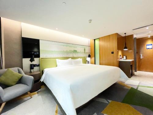 Imagen de la habitación del Hotel Hampton by Hilton Guangzhou Tianhe Sports Center. Foto 17