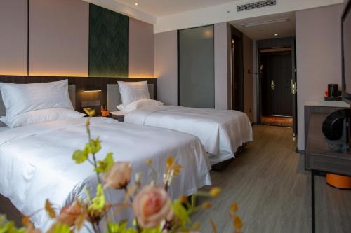 Imagen de la habitación del Hotel HanTang Haikou Business College Sun Moon Plaza Duty Free Shop. Foto 10