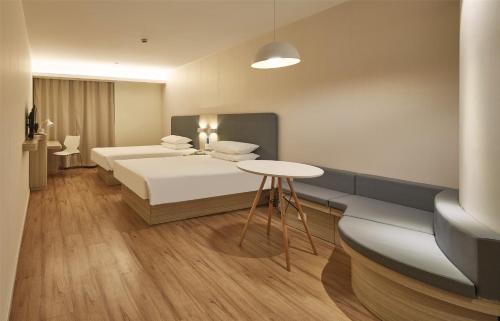Imagen de la habitación del Hotel Hanting Express Shanghai Zhoupu Yigu. Foto 5