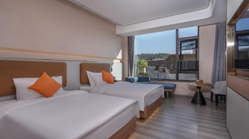 Imagen de la habitación del Hotel Hawthorn by Wyndham Honghe Mile Hot Spring. Foto 20