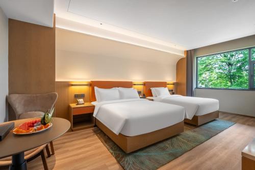 Imagen de la habitación del Hotel Hawthorn by Wyndham Xishuang Banna Jinghong. Foto 19