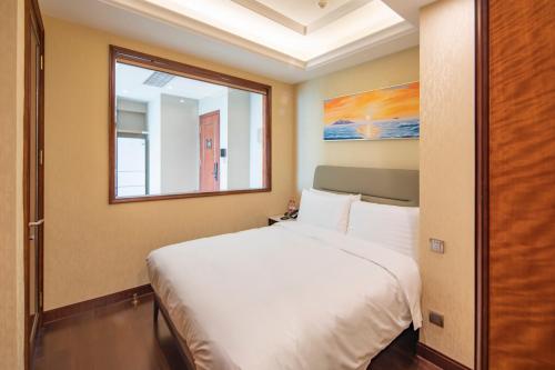 Imagen de la habitación del Hotel Hengli Dalian. Foto 20
