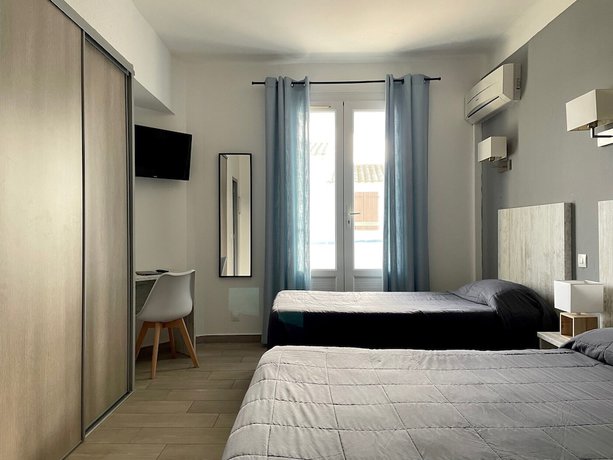 Imagen de la habitación del Hotel Hôtel Les Palmiers en Camargue. Foto 17