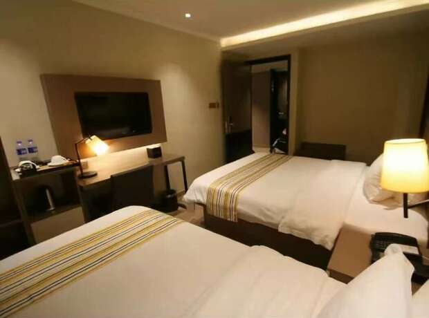 Imagen de la habitación del Hotel Home Inns Collection. Foto 19