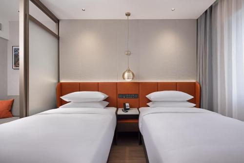 Imagen de la habitación del Hotel Home2 Suite by Hilton Harbin Central Street. Foto 20