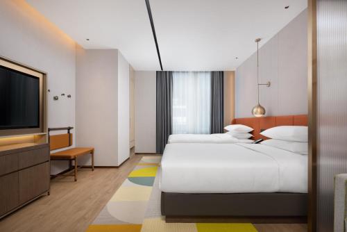 Imagen de la habitación del Hotel Home2 Suite by Hilton Jingjiang Binjiang New Town. Foto 14