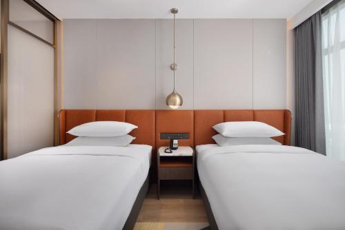 Imagen de la habitación del Hotel Home2 Suite by Hilton Rizhao Wanpingkou. Foto 16