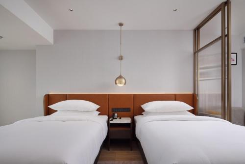 Imagen de la habitación del Hotel Home2 Suites by Hilton Nanning. Foto 17