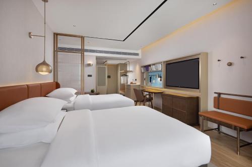 Imagen de la habitación del Hotel Home2 Suites by Hilton Nanning. Foto 20