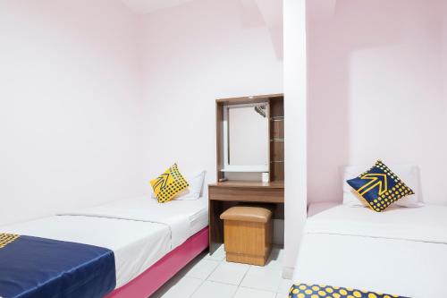 Imagen de la habitación del Hotel Hotel O Wisma Jampea. Foto 14