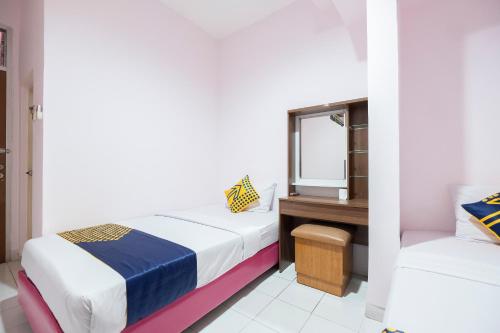 Imagen de la habitación del Hotel Hotel O Wisma Jampea. Foto 15