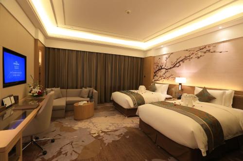 Imagen de la habitación del Hotel Howard Johnson Xiangyu Plaza Linyi. Foto 4