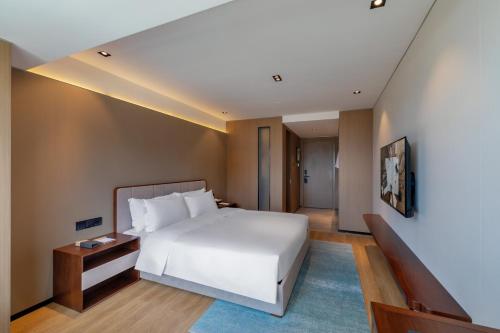 Imagen de la habitación del Hotel Huawen Four Season. Foto 16