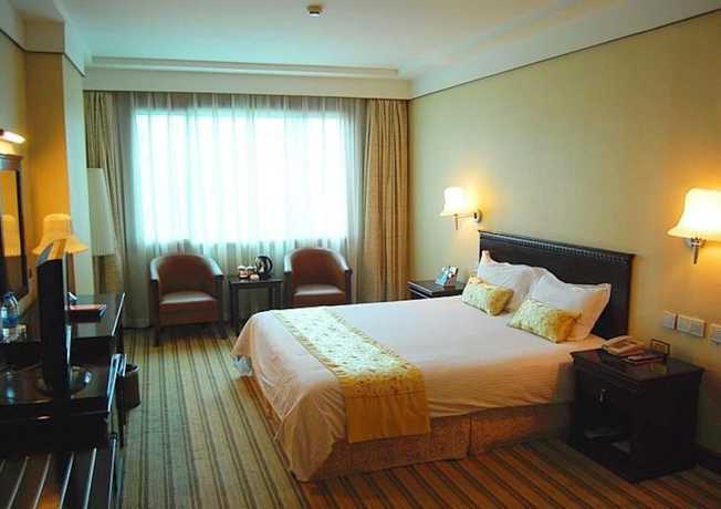 Imagen de la habitación del Hotel Huaxia Hotel. Foto 11