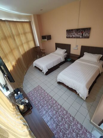 Imagen de la habitación del Hotel Indah Inn. Foto 14