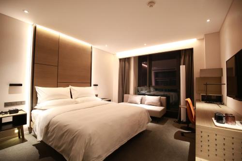 Imagen de la habitación del Hotel Innside Zhengzhou. Foto 8