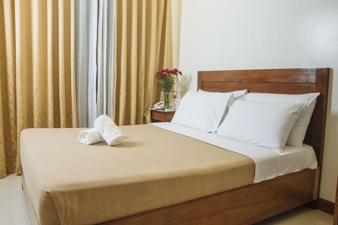 Imagen de la habitación del Hotel Ipil Suites Puerto Princesa. Foto 11