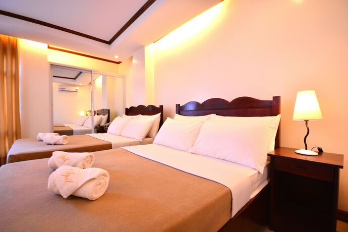 Imagen de la habitación del Hotel Ipil Suites Puerto Princesa. Foto 18