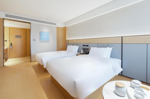 Imagen de la habitación del Hotel JI Wuhan Baishazhou Hongshan Vanke Plaza Branch. Foto 14