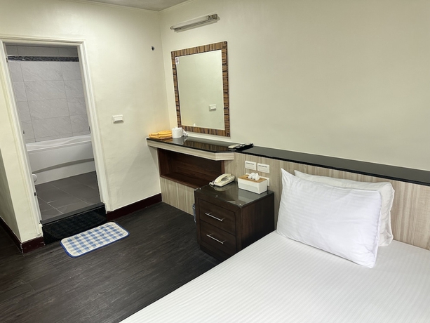 Imagen de la habitación del Hotel JianGuo. Foto 14