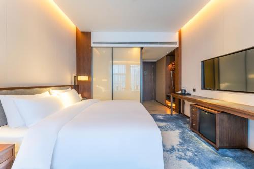Imagen de la habitación del Hotel Jinan Ziyue Meixiu. Foto 18