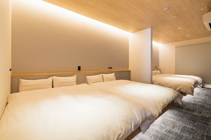 Imagen de la habitación del Hotel J-stay Beppu Indigo. Foto 18