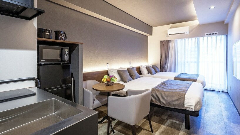 Imagen de la habitación del Hotel Kariyushi Condominium Resort Naha GSA. Foto 13