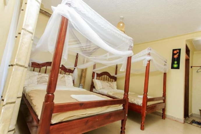 Imagen de la habitación del Hotel Kyaninga Royal Cottage. Foto 13
