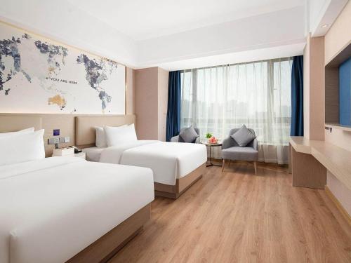 Imagen de la habitación del Hotel Kyriad Guigang Wuyue Plaza Railway Station. Foto 18