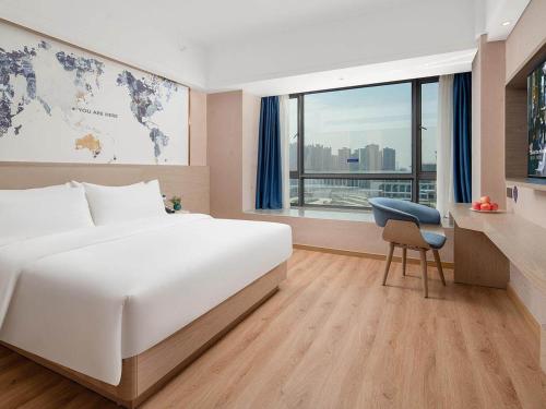 Imagen de la habitación del Hotel Kyriad Guigang Wuyue Plaza Railway Station. Foto 19