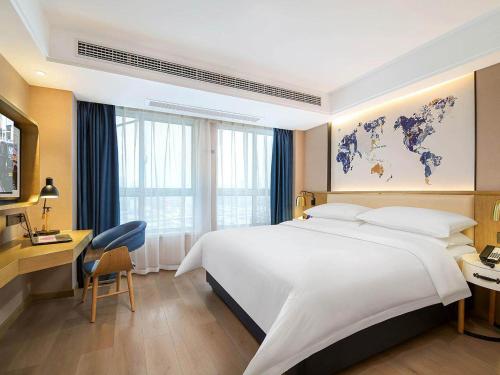 Imagen de la habitación del Hotel Kyriad Marvelous Henan Xinyang Pingqiao Plaza. Foto 12