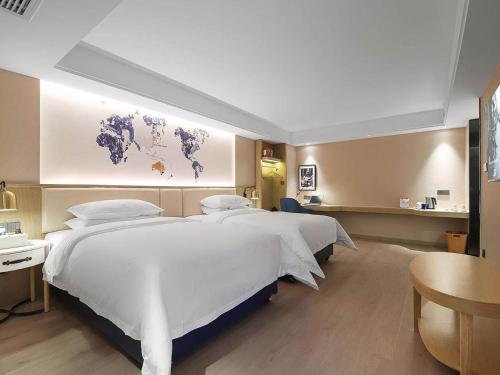 Imagen de la habitación del Hotel Kyriad Marvelous Henan Xinyang Pingqiao Plaza. Foto 13