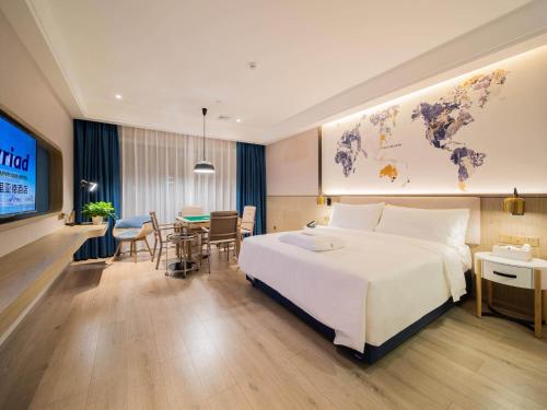 Imagen de la habitación del Hotel Kyriad Marvelous Heyuan Hakka Culture Park. Foto 19