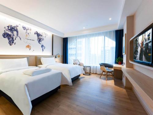 Imagen de la habitación del Hotel Kyriad Marvelous Heyuan Wanda Plaza. Foto 13