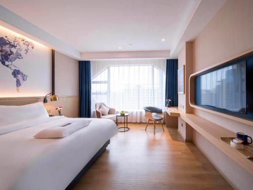 Imagen de la habitación del Hotel Kyriad Marvelous Heyuan Wanda Plaza. Foto 15